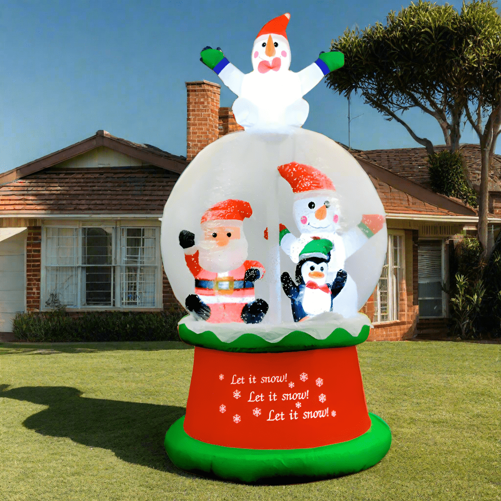 Inflatable snow globe with cartoon characters on a snowy outdoor setting