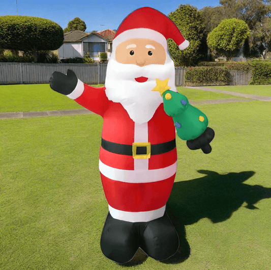 Inflatable Santa Claus figure holding a star and a green bag on a white background